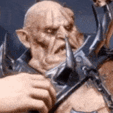 a close up of a person holding a sword in front of a monster .