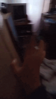 a blurry picture of a person 's hand reaching for something