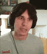 a man wearing headphones and a t-shirt that says ' bomber ' on it