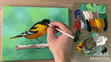 a person is painting a bird on a canvas with the words made in animotica on the bottom