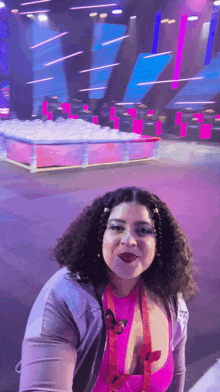 a woman wearing a pink top with a lanyard that says ' butterfly ' on it