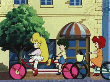 three children are riding tandem bicycles in front of a yellow building