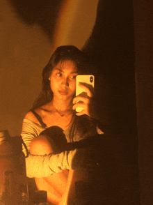 a woman is taking a selfie with her phone