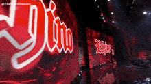 a man stands in front of a large screen that says ' yjin '