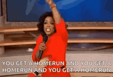 oprah winfrey is holding a microphone and saying `` you get a homerun and you get a homerun ''