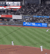 a baseball game is being played in a stadium with ny on the scoreboard