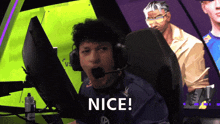 a man wearing headphones says nice in front of a computer