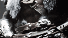 a blurred image of a person wearing armor and a fur coat