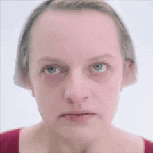 a close up of a woman 's face with a blurred background .