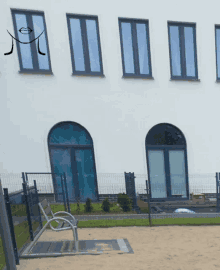 a white building with a drawing of a face on the windows
