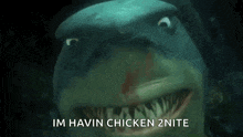 a shark is swimming in the water and making a funny face .