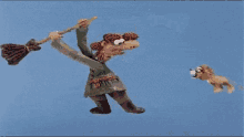 a cartoon of a witch flying with a broom and a dog