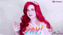 a woman with red hair and a tiara on her head is wearing a wig and a white dress .