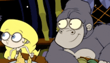 a girl and a gorilla are sitting at a table with a plate of food