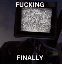 a man in a suit and tie is standing in front of a tv screen that says fucking finally
