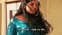 a woman in a blue sequined top is saying `` this sucks , i hate my life . ''