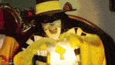 a man in a mcdonald 's costume is holding a bag with a key in it