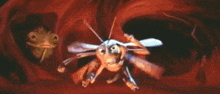 a cartoon of a bee eating another bee in a red cave .