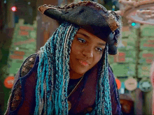 a woman with blue braids and a pirate hat on