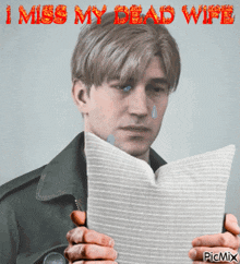 a man holding a piece of paper with the words i miss my dead wife on it