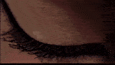 a close up of a woman 's eye with a reflection of the letter o