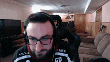 a man wearing glasses and headphones is wearing a shirt that says mobil 1