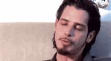a close up of a man with his eyes closed .