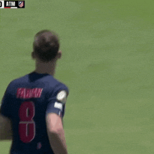 a soccer player wearing a jersey with the number 8 on the back