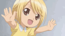 a little girl is waving her hands in the air .