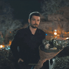 a man holding a broken umbrella with minimalmoons on the bottom
