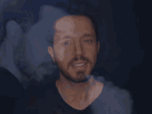 a close up of a man 's face with another man 's face in the background