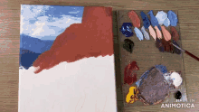 a painting is being painted on a canvas next to a palette of paint and the words made in animatica