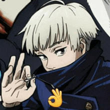 a close up of a person 's face with a hand making an ok sign .