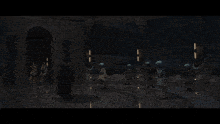 a group of people are standing in a room with a fireball coming out of the ceiling