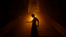 a man is standing on a set of stairs in the dark