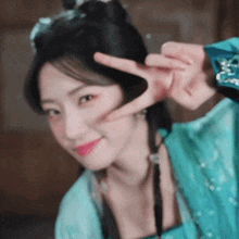 a woman making a peace sign with her hands