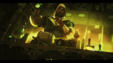 a man with a beard is holding a green bottle in his hand