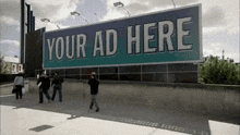 a group of people walking past a billboard that reads your ad here