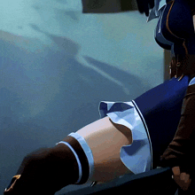a close up of a person 's leg with a blue skirt on