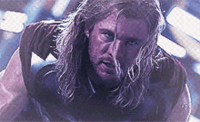 a close up of a man with long hair