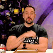 a man with a beard wears a t-shirt that says " nerable agrant "