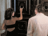 a man and a woman are standing in front of a door .