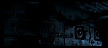 a dark room with a few lights on the walls and ceiling