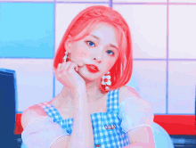 a girl with red hair is wearing a blue and white dress