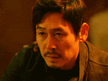 a close up of a man 's face with a black shirt
