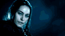 a blurry picture of a woman holding a sword in her hand