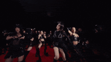 a woman in a black top is surrounded by a group of women