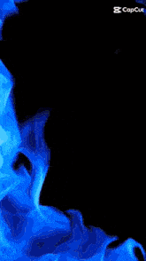 a man is sitting in front of a blue flame with the caption capcut at the bottom