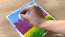 a person is painting a picture with the words wow art behind them