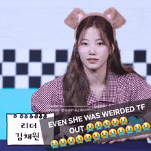 a girl wearing a headband that says even she was weirded tf on it